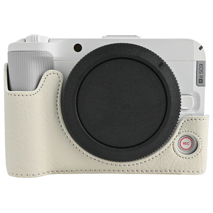 For Canon EOS R50 V Camera Half Case Litchi Texture Battery Opening PU Leather Cover with Shoulder Strap and Lens Cap