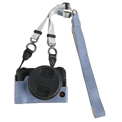 For Canon EOS R50 V Camera Half Case Litchi Texture Battery Opening PU Leather Cover with Shoulder Strap
