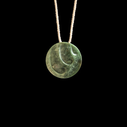 Jade disc pendant with korus by Madelyne Gourdin Necklace