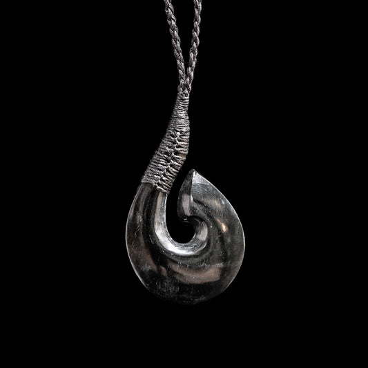 Hand-carved Onewa stone Matau by Alex Sands Pendant